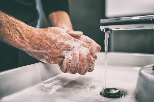 A man washing his hands with soap.